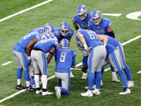 Detroit Lions quarterback Matthew Stafford (9) talks with his teammates in the huddle during the second half of an NFL football game between...