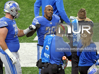 Detroit Lions running back Adrian Peterson (28) is congratulated after making a touchdown during the second half of an NFL football game bet...