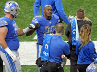 Detroit Lions running back Adrian Peterson (28) is congratulated after making a touchdown during the second half of an NFL football game bet...
