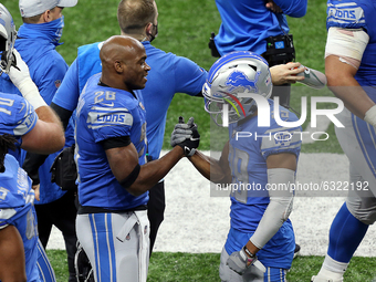 Detroit Lions running back Adrian Peterson (28) is congratulated by Detroit Lions wide receiver Jamal Agnew (39) after making a touchdown du...