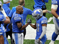 Detroit Lions running back Adrian Peterson (28) is congratulated by Detroit Lions wide receiver Jamal Agnew (39) after making a touchdown du...