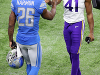 Detroit Lions strong safety Duron Harmon (26) greets Minnesota Vikings free safety Anthony Harris (41) at the conclusion of an NFL football...