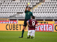 Marco Di Bello shows the yellow card to Andrea Belotti during the Serie A football match between Torino FC and Hellas Verona FC at Stadio Ol...
