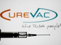Medical syringe is seen with CureVac logo displayed in the background in this illustration photo taken in Poland on January 7, 2021. Bayer a...