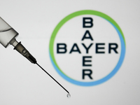Medical syringe is seen with Bayer logo displayed in the background in this illustration photo taken in Poland on January 7, 2021. Bayer and...