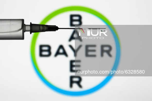 Medical syringe is seen with Bayer logo displayed in the background in this illustration photo taken in Poland on January 7, 2021. Bayer and...