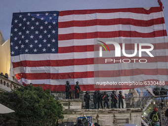 Police formed along a flag that Trump supporters issue in US Capitol,  on January 06, 2021 in Washington, DC. The protesters stormed the his...