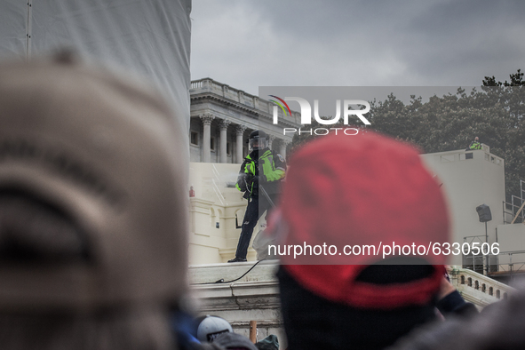 A policeman try to disperse the crowd near the U.S. Capitol on January 06, 2021 in Washington, DC. The protesters stormed the historic build...