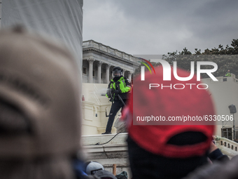 A policeman try to disperse the crowd near the U.S. Capitol on January 06, 2021 in Washington, DC. The protesters stormed the historic build...