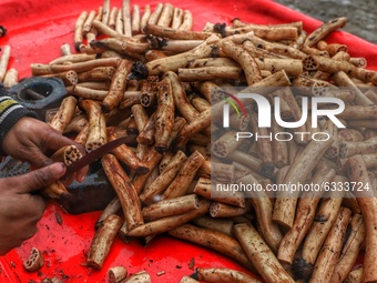 A vendor selling Lotus Stem (Nadru) outside General Bus stand Sopore District Baramulla Jammu and Kashmir India on 09 January 2021 (