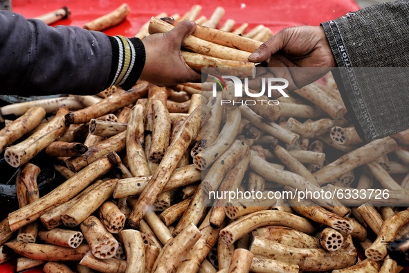 A vendor selling Lotus Stem (Nadru) outside General Bus stand Sopore District Baramulla Jammu and Kashmir India on 09 January 2021 