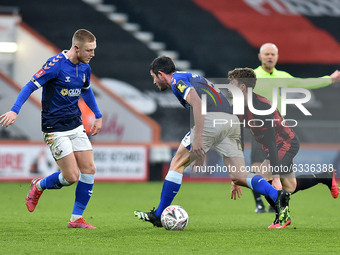 Oldham Athletic's Davis Keillor-Dunn and Oldham Athletic's Ben Garrity tussle with Gavin Kilkenny of Bournemouth  during the FA Cup match be...