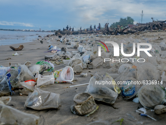 Hundreds of Jimbaran villagers worked together to clean up tens of tons of trash stranded on Muaya Beach, on January 10, 2021. This environm...