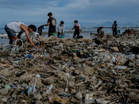 Hundreds of Jimbaran villagers worked together to clean up tens of tons of trash stranded on Muaya Beach, on January 10, 2021. This environm...