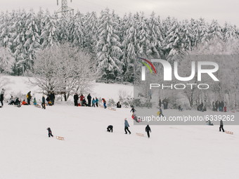 peope play and ski on snow covered field in  Ramerbach due to the hard lock down large ski resorts are closed down (