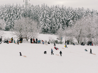 peope play and ski on snow covered field in  Ramerbach due to the hard lock down large ski resorts are closed down (