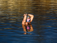 A winter swimmer wears a face mask while dipping in cold waters of Zakrzowek lake, a former limestone quarry located close to the city cente...