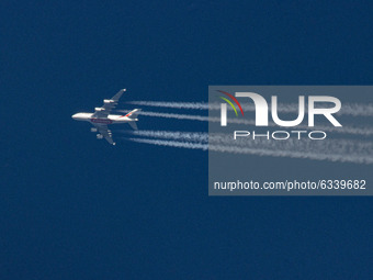 Emirates Airbus A380 aircraft as seen flying in the blue sky over the Netherlands in Europe the route from Dubai DXB, UAE to Manchester MAN...