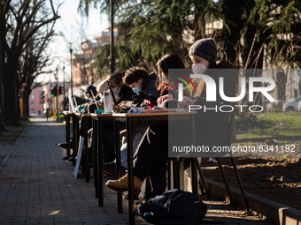 Italian students study with computers and books outside the Calini's High School in Brescia, Italy, on January 11, 2021 during a demonstrati...