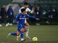 Takefusa Kubo of Getafe and Antonio Barragan of Elche compete for the ball during the La Liga Santader match between Elche CF and Getafe CF...