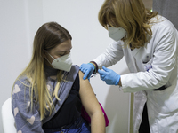 Healthcare workers receive the Pfizer-BioNtech Coronavirus vaccine at Vaccine hub near the 'Mostra d'Oltremare' venue, in Naples, Italy, on...