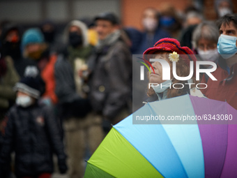 A woman with a colored umbrella looks at the concert. The NGO D.A.L. (ie Right To Housing) organized an happening near a squat they opened s...