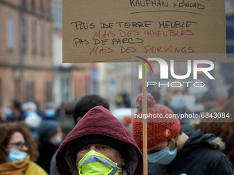 A man holds a placard reading 'Toulouse up to sale'. The NGO D.A.L. (ie Right To Housing) organized an happening near a squat they opened so...