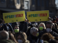  protesters hold banners during a demonstration by tourist agencies, operators and guides at Piazza del Popolo in Rome on January 12, 2021....