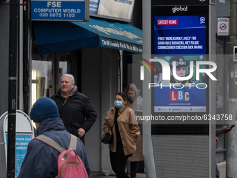 People walk past a public display message in Wandsworth, South West London, showing Met Police Commissioner Cressida Dick warning about risk...