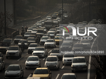 Vehicles travel on a road in northern Tehran during a polluted air, following the COVID-19 outbreak in Iran, on January 12, 2021. Tehran is...