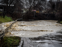 Katinska river overflowing it's banks and floods road in Novi Iskar, Bulgaria 12 January,2021 (