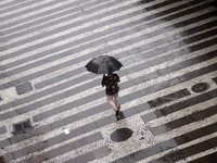 Pedestrians walk on a rainy day through the streets of São Paulo, Brazil, on January 12, 2021. (