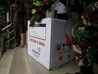 Health workers unloading container box of the coronavirus vaccine made by Sinovac Biotech Ltd. at a public health facilities in Jakarta on J...