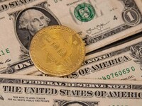 Bitcoin golden physical coin illustration on United States Dollar banknotes. Visual representations of the digital Cryptocurrency Bitcoin wi...