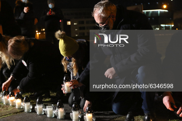 People lighting candles in a giant heart shape are seen during the Pawel Adamowicz in memoriam meeting in Gdansk, Poland on 13 January 2021...