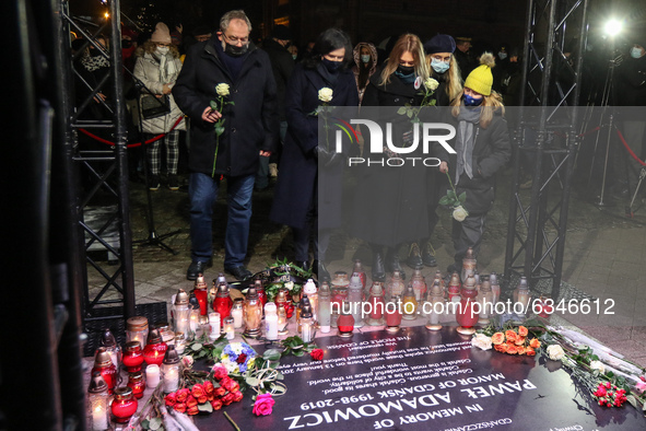(L-R) Piotr Adamowicz, Aleksandra Dulkiewicz , Magdalena Adamowicz and her daughters in front of memorial plaque are seen during the Pawel A...