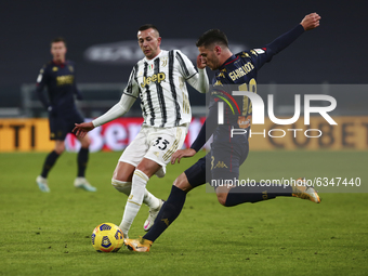 Paolo Ghiglione of Genoa CFC and Federico Bernardeschi of Juventus FC compete for the ball during the Italy Cup match between Juventus FC an...