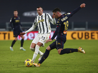 Paolo Ghiglione of Genoa CFC and Federico Bernardeschi of Juventus FC compete for the ball during the Italy Cup match between Juventus FC an...