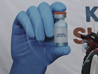 A healthcare worker walk past a poster vaccination after receiving the Sinovac vaccine at the health office in Bogor, West Java, Indonesia o...