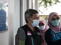 Dr. MUHAMMAD HELMI MM (left) , from South Jakarta Health District administration supervise the vaccination process with Dr. SUSILOWATI  (rig...
