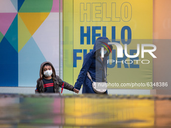  A mother and son in face masks in the rain on Market Street during a third national lockdown on Thursday 14th January 2021.  (