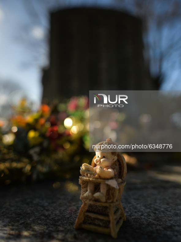 Figurines and flowers seen at the memorial commemorating more than 200 children from Bethany Mother and Child Home at Mount Jerome Cemetery...