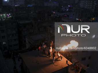 People set up party lights on a rooftop to celebrate Sakrain festival in Dhaka, Bangladesh on Thursday, January 14, 2021. (