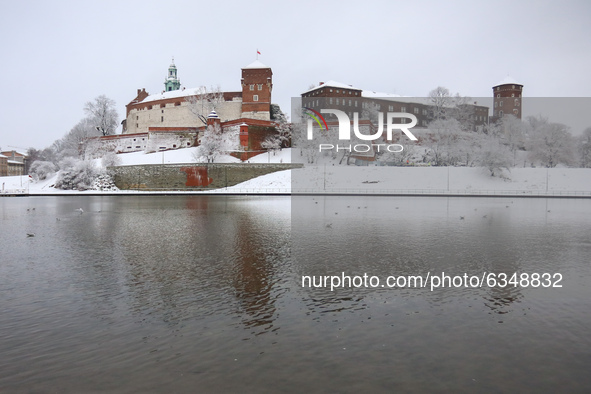 A view over Vistual River and Wawel Castle covered with snow in Krakow, Poland. January 14, 2021. 