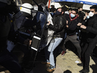 University students clash with riot police during a rally in Athens, Thursday, Jan. 14, 2021. Police have used tear gas to disperse crowds a...