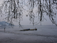 Stranded shikaras remain stuck in ice inside t frozen Dal Lake, Srinagar, Indian Administered Kashmir on 14 January 2021.  Srinagar city wit...