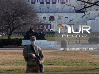 A member of the National Guard is seen at the US Capitol a day after The House of Representatives impeached President Trump for inciting an...