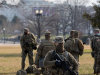 Members of the National Guard gather at the US Capitol a day after The House of Representatives impeached President Trump for inciting an in...