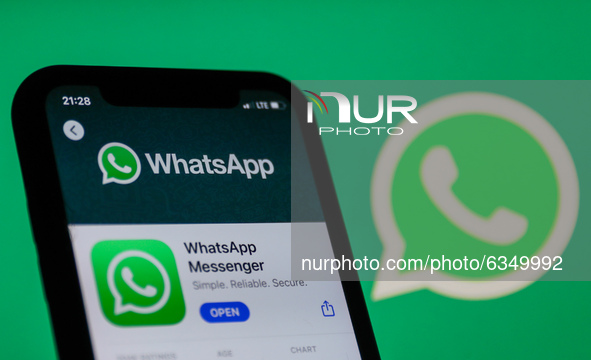 WhatsApp logo on the App Store displayed on a phone screen and WhatsApp logo in the background are seen in this illustration photo taken in...
