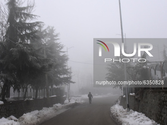 A man walks amid dense fog in Srinagar, Indian Administered Kashmir on 15 January 2020. The temprature in Srinagar dipped to -8.4 Celsius on...